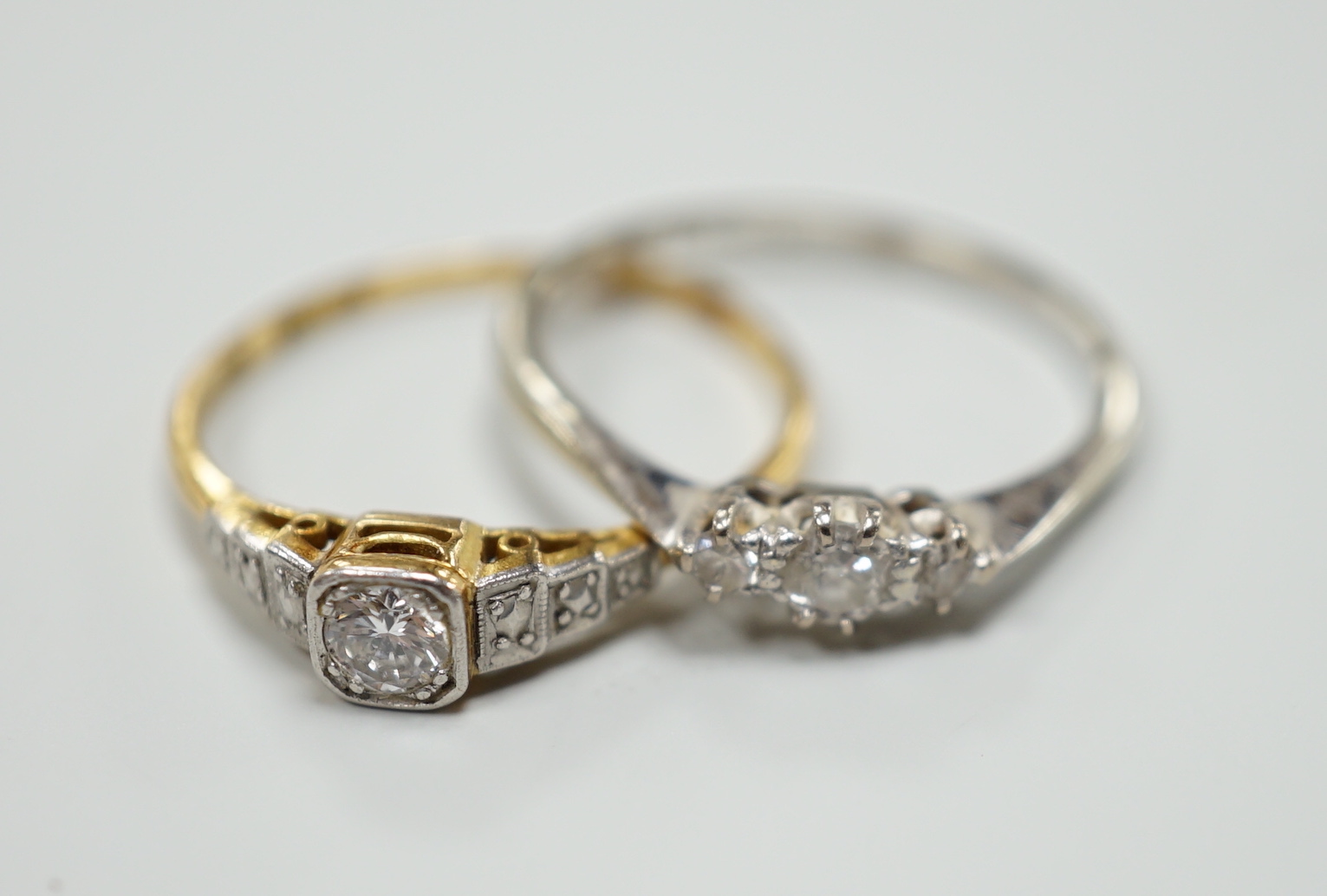 Two 18ct,plat and diamond set rings including single stone, size Q and three stone, size O/P, gross weight 4.3 grams.